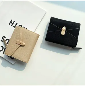 Close-up of pebble leather short wallet with metal buckle and contrast stitching