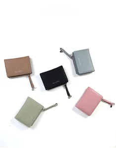 Detail showing five colors of small zip wallets with lychee pattern leather and wrist straps