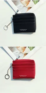 Detail of lychee textured card holders in black and red with a silver keychain ring