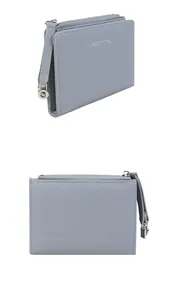 Detail of light blue textured leather wallet with zipper closure and silver classic text