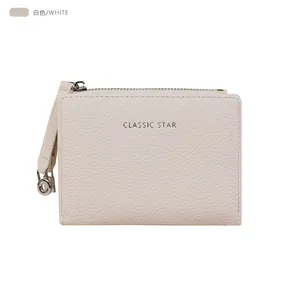 Detail of white lychee pattern leather wallet with gold zipper and Classic Star logo