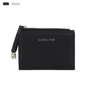 Detailed macro shot of black lychee grain wallet with silver Classic Star lettering