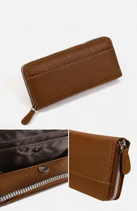 Detail view of brown long wallet with litchi grain texture and secure metal zipper