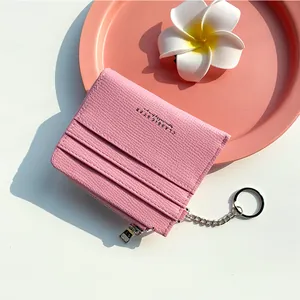 Pink minimalist card holder with zipper pocket and metal keychain accessory
