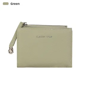 Detail view of olive green leather wallet with Classic Star logo and litchi texture