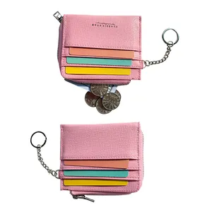 Pink lychee leather card holder with colorful slots, zipper pouch, and silver keychain