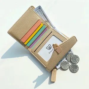 Minimalist beige pebble leather tri-fold wallet with colorful card slots and gold clasp