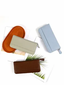Three long leather wallets with litchi texture in light green, blue, and brown shades