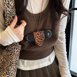Chic leopard print leather sunglasses holder worn as a stylish neck accessory