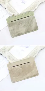 Detail of slim faux leather card holder with gold zipper and textured card slots