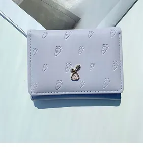 Détail du portefeuille lilas avec gaufrage carotte et ornement de lapin en métal