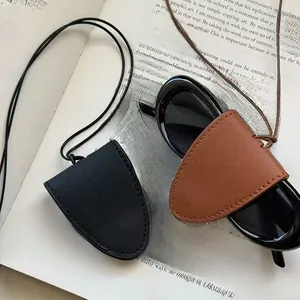 Close-up of leather sunglasses holder pouches in black and brown with neck strap