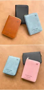 Flat lay of colorful RFID travel wallets with zipper and embossed airplane pattern