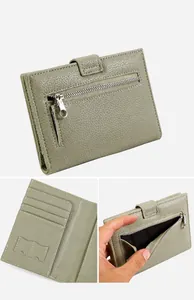 Detail view of bean green litchi grain leather passport wallet with silver metal zipper
