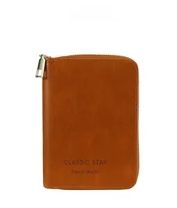 Detail of brown leather RFID travel wallet showing airplane logo and gold metal zipper