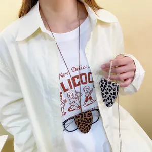 Chic leopard print magnetic glasses holder clip with lanyard worn as a stylish accessory