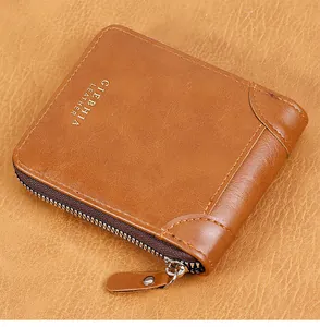 Close-up of vintage brown leather wallet showing high-quality stitching and metal zipper