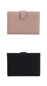 Detailed view of pink and black lychee grain leather passport wallet with snap closure