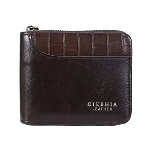 Detail of dark brown leather wallet with crocodile texture mix and metal zipper
