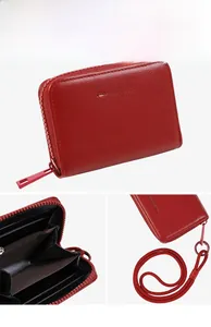 Detail of red pebbled leather wallet with zipper closure and multiple card slots