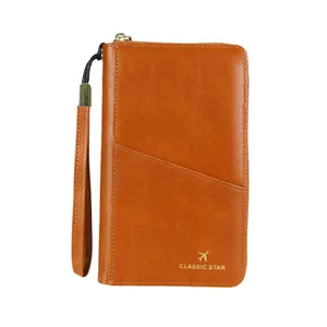 Braune RFID Reisepasshülle aus Leder mit goldenem Flugzeug-Logo und Handschlaufe