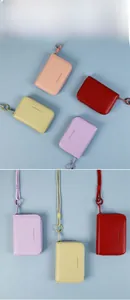 Detail of candy-colored leather wallets with zip closure and lanyards in various colors