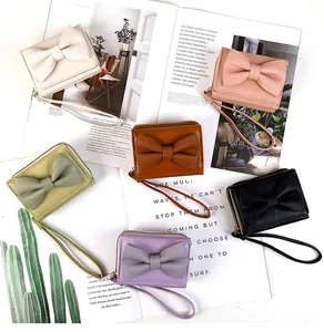 Detail view of stylish bow-knot PU leather wallets in six trendy colors with wrist straps