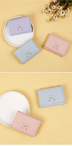 Detailed view of pastel PU leather wallets with cute bear and tulip embroidery decorations