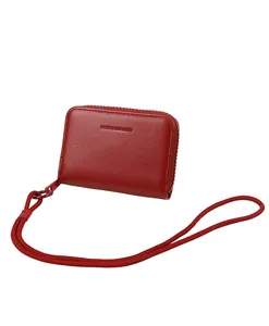 Detail of red litchi texture coin purse with zipper and Forever Sunshine embossed logo