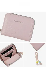 Detail of pink pebbled leather coin purse with accordion slots and beaded zipper pull