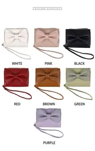 Detailed color selection of mini bow wallets in white, pink, black, brown, and green
