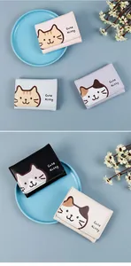 Detailed view of trifold PU leather wallets featuring cute kitty prints and snap button closure