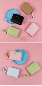 Detailed macro shot showing five colorful crocodile pattern leather coin purses with beaded pulls