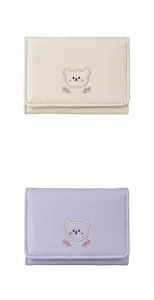 Detailed embroidery of a cartoon bear and pink tulips on a soft PU leather wallet