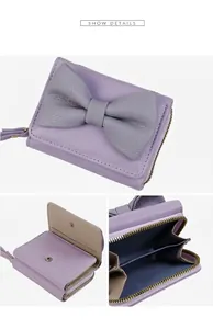 Detail view of tri-fold lavender PU leather wallet with gray bow and tassel zipper