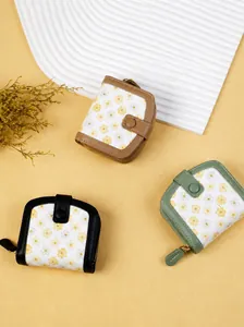Three fresh canvas wallets with daisy print, leather trim, and zipper closure detail