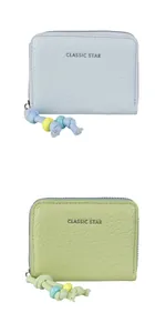 Detail of colorful beaded zippers on light blue and green pebble leather coin purses