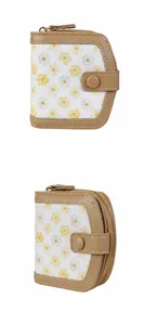 Detail view of small floral wallet with smooth zipper and khaki leather snap closure