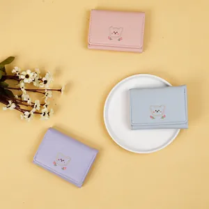 Three embroidered bear PU leather wallets in pink, light blue and purple colors