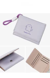 Detailed interior and exterior views of a lavender tri-fold wallet with cartoon cat pattern