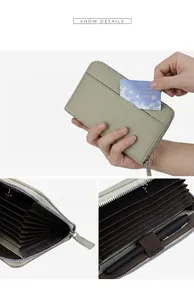 Detail view of sage green leather accordion wallet with card slots and a pen holder