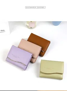 Detailed view of women's short wallets with gold wavy hardware in various pastel colors