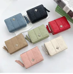 Flat lay of diverse textured leather coin purses with floral embossing and metal clasps