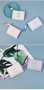 Detailed close-up of cute pastel bear print tri-fold wallets with woven lanyards