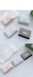 Detailed close-up of compact plaid wallets with cute girl label and bow prints
