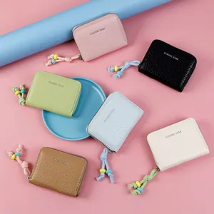 Small faux leather wallets with crocodile texture and colorful beaded tassels in multiple colors