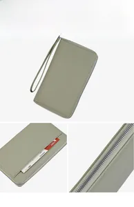 Detail of pea green litchi texture passport wallet with wristlet and exterior card slot