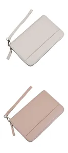 Close-up of litchi grain texture on long leather wallets with secure wrist straps