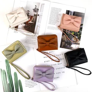 Short PU leather bow wallet for women in multiple colors with wrist strap and zipper