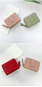 Detail of clover zip wallet with flower embossing and butterfly crystal buckle decoration